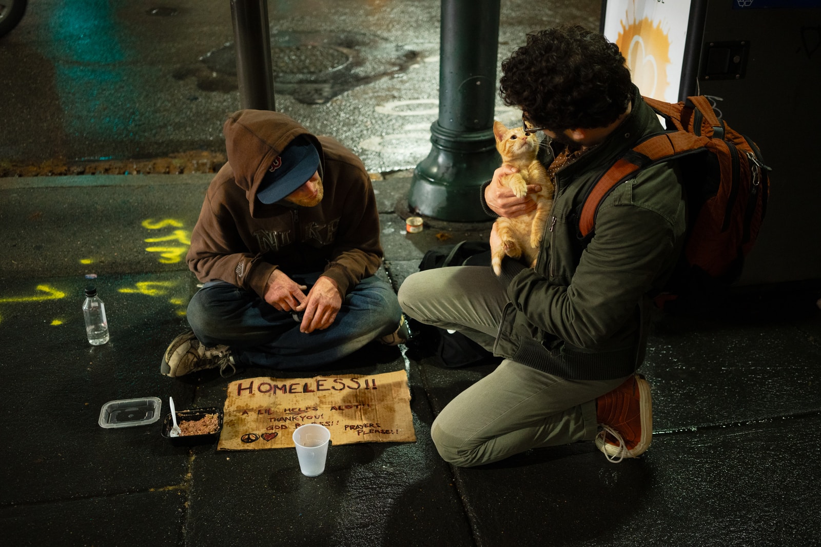 Photo by Zac Durant two men sitting on road