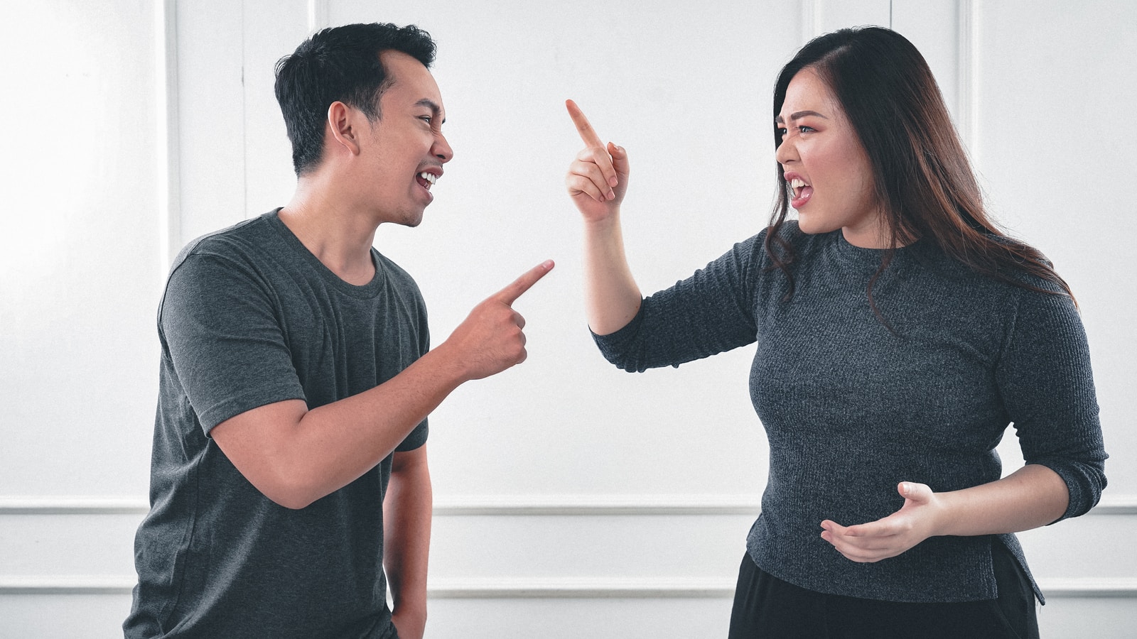 Photo by Afif Kusuma man in gray crew neck long sleeve shirt standing beside woman in black crew neck shirt