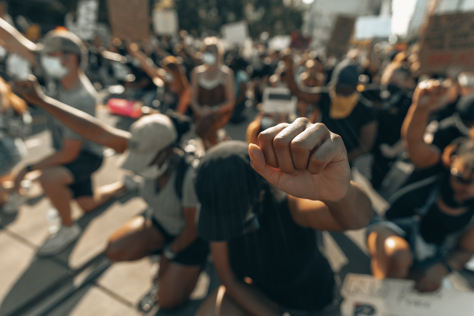 Photo by Clay Banks people in black shirts and black shorts sitting on bench during daytime
