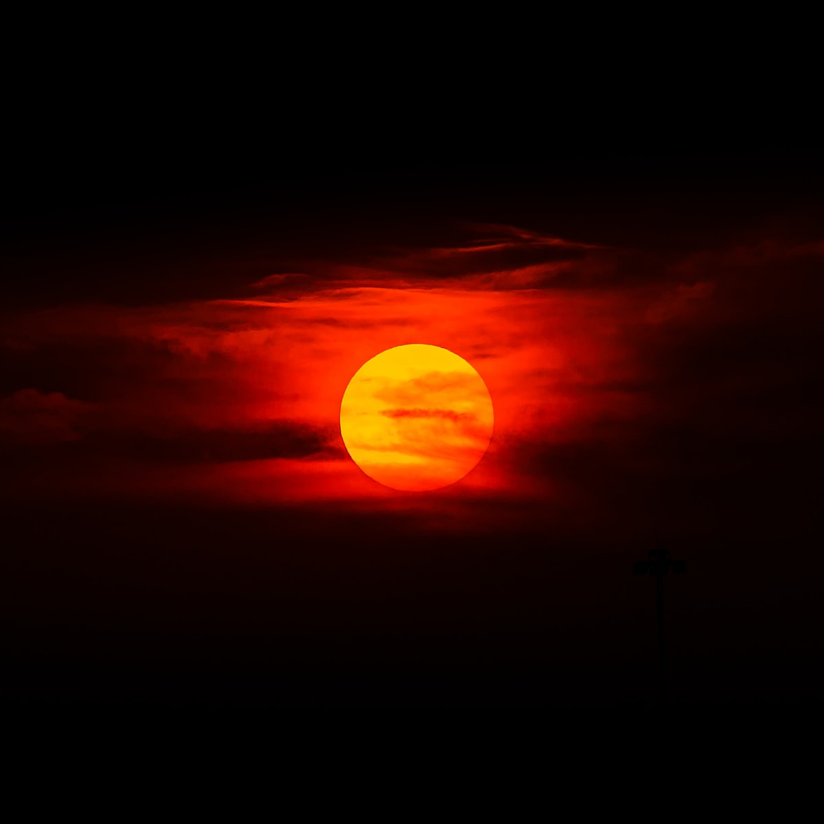 Photo by Jared Murray sun setting over the clouds