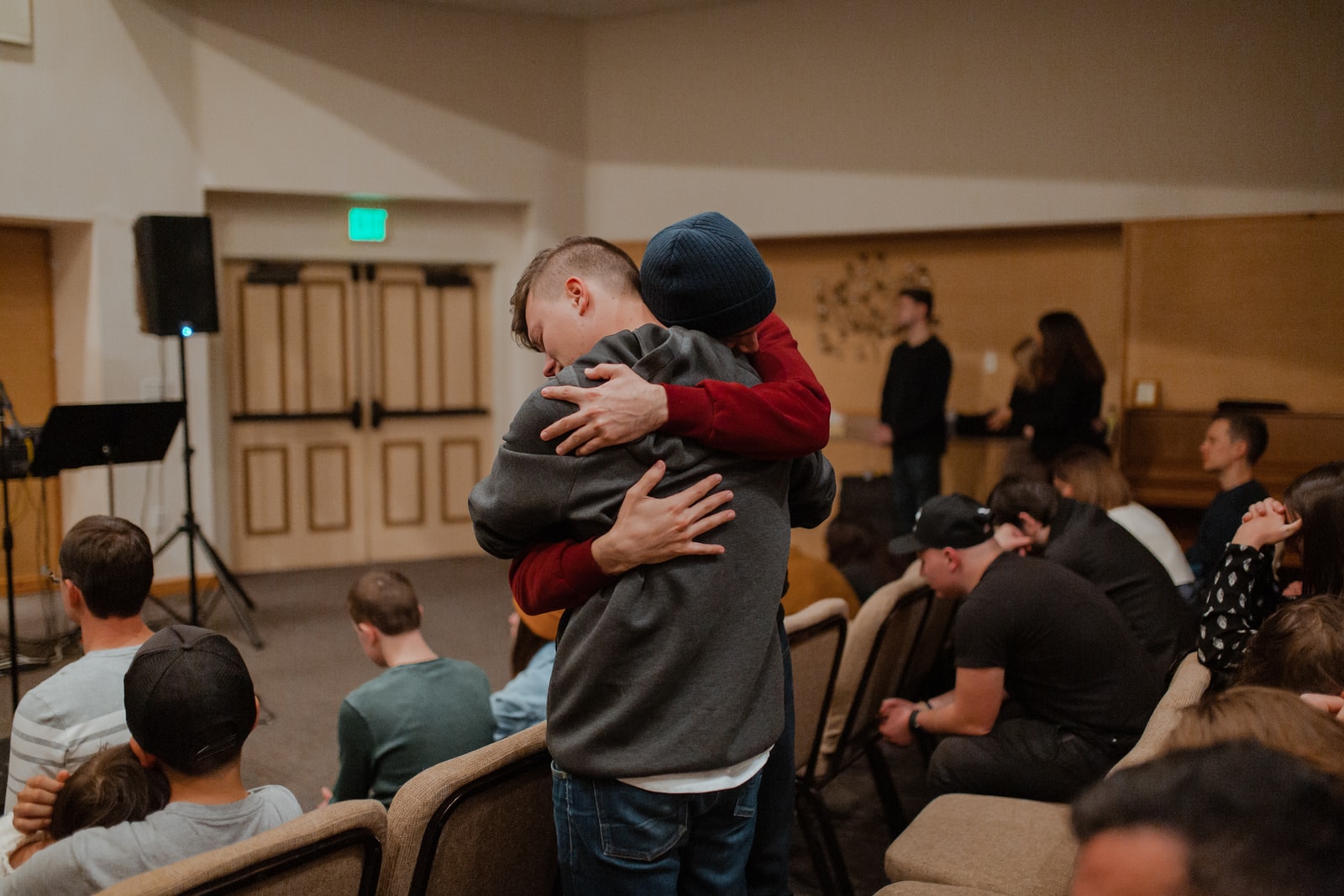 Photo by adrianna geo man in gray sweater carrying woman in black jacket