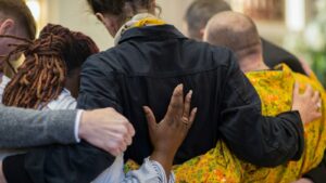 Grieving people supporting one another