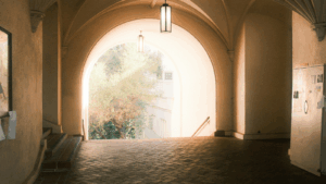 photo of an arched door opening to light