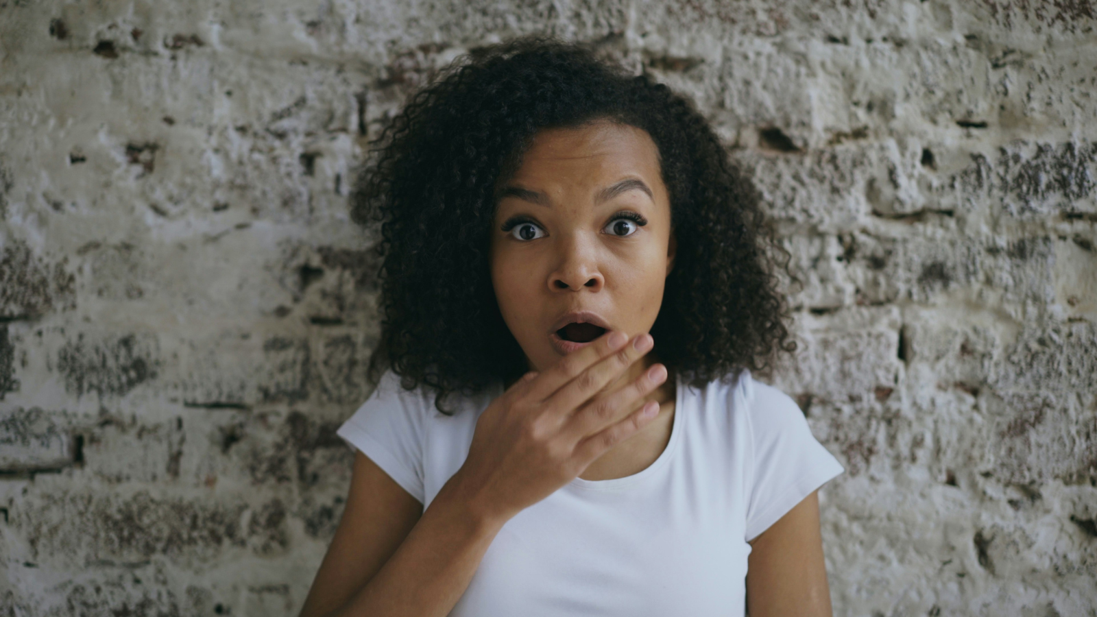 Photo by <a href="https://unsplash.com/@silverkblack">Vitaly Gariev</a> on <a href="https://unsplash.com/photos/a-surprised-woman-with-hand-over-her-mouth-j4w_JdK_nEg">Unsplash</a>; licensed under CC0.